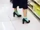 Women wearing mint colour socks with black shoes and black knee length skirt