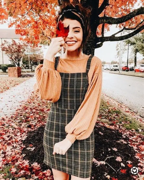 Women wearing pinafore plaid dress with red lipstick smiling 