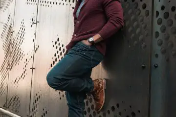 Man wearing a maroon cardigan with skinny jeans and brown boots