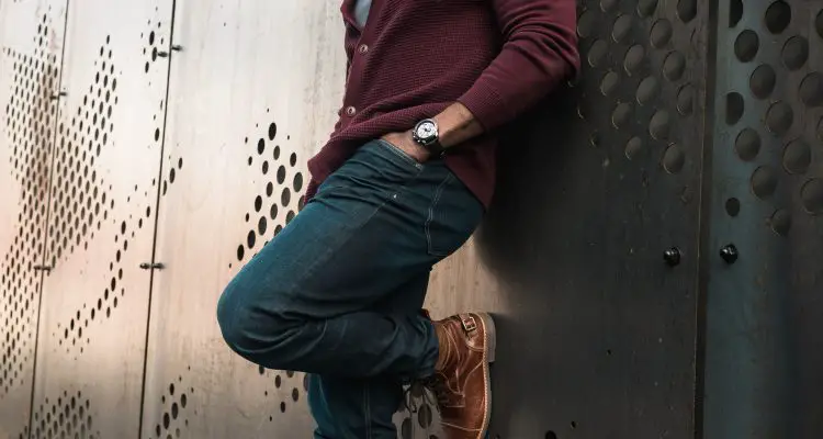 Man wearing a maroon cardigan with skinny jeans and brown boots