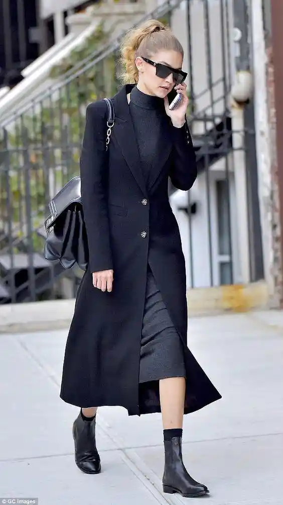 dailymail.co.uk - Gigi Wearing black long coat with black sunglasses, black dress and black ankle boots