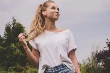 woman wearing white t-shirt and button up denim skirt