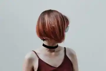woman wearing retro glasses and choker with short hair
