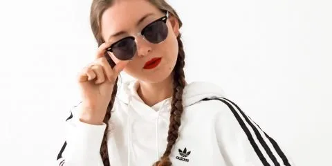 Women wearing adidas crop hoody red lipstick and sunglasses