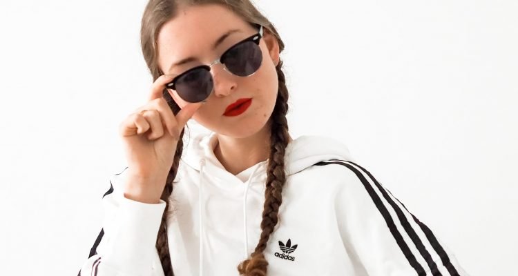 Women wearing adidas crop hoody red lipstick and sunglasses